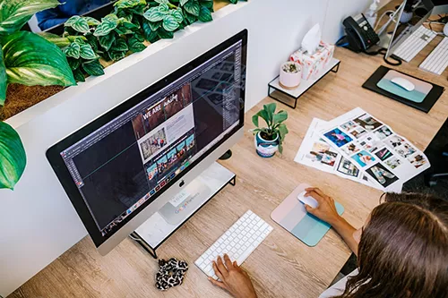 Graphic designer working on branding and static website visuals for small business clients